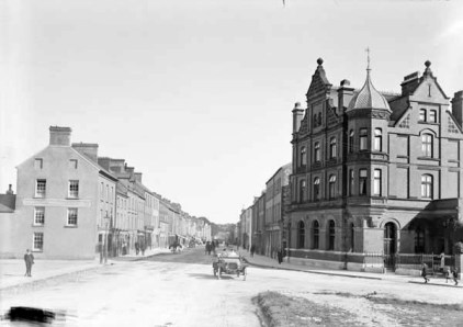 The red-brick Munster and Leinster bank designed by Pugin's son-in-law GC Ashlin still dominates the northern end of Midleton's Main Street. This photo was taken shortly after the bank opened in 1901.
