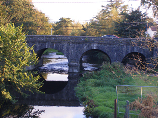 The five arched bridge leading from the northern end of  Midleton town center to Cork. It has one end higher than the other due to the high ground sloping down on western bank of the Owenacurra River.