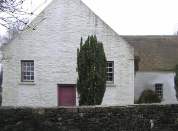 The reconstructed Mountjoy Presbyterian Meeting House in the Ulster American Folk Park. Note the similarity to the Tullyallen Masshouse, although the windows are smaller and higher.