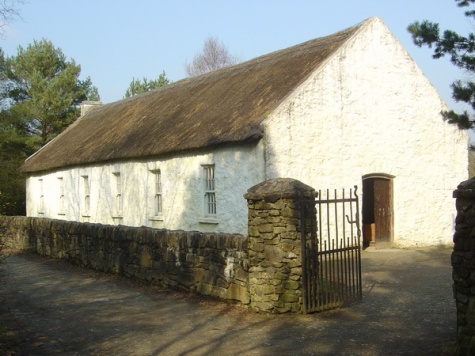 Tullyallen Masshouse from near Dungannon was built in 1768 on land leased from the liberal Lord Charlemont. Here we see the west door, the plain white walls, thatch and the chimney at the opposite end indicating the schoolroom. The priest lived in a wing at the back. Surprisingly few of these buildings survive in Ireland. Most were replaced in the early 19th century.  