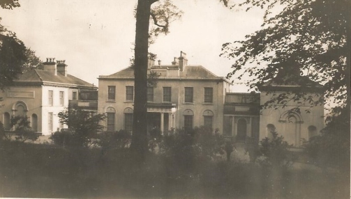 The entrance front of Ballyedmond House faced due north, allowing the drawing room and dining room to enjoy fine views to the south over Midleton. The staircase was located behind the two windows on the right of the porch. Note the chaste late Georgian style of the central block and the slightly more elaborate decoration of the two wings.